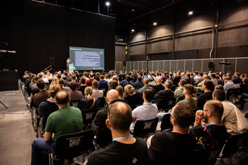 Back-of-room view of hundreds of attendees