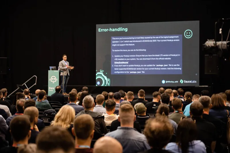 Nikolay presenting on stage at InfoShare 2023